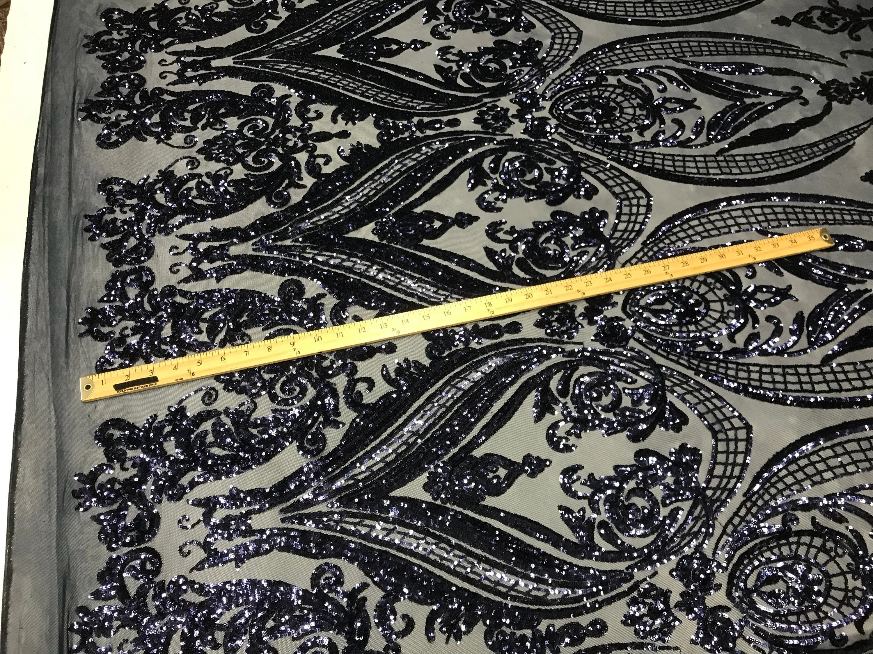 Navy blue princess design embroidery with shiny sequins on a 4 way stretch mesh-sold by the yard.