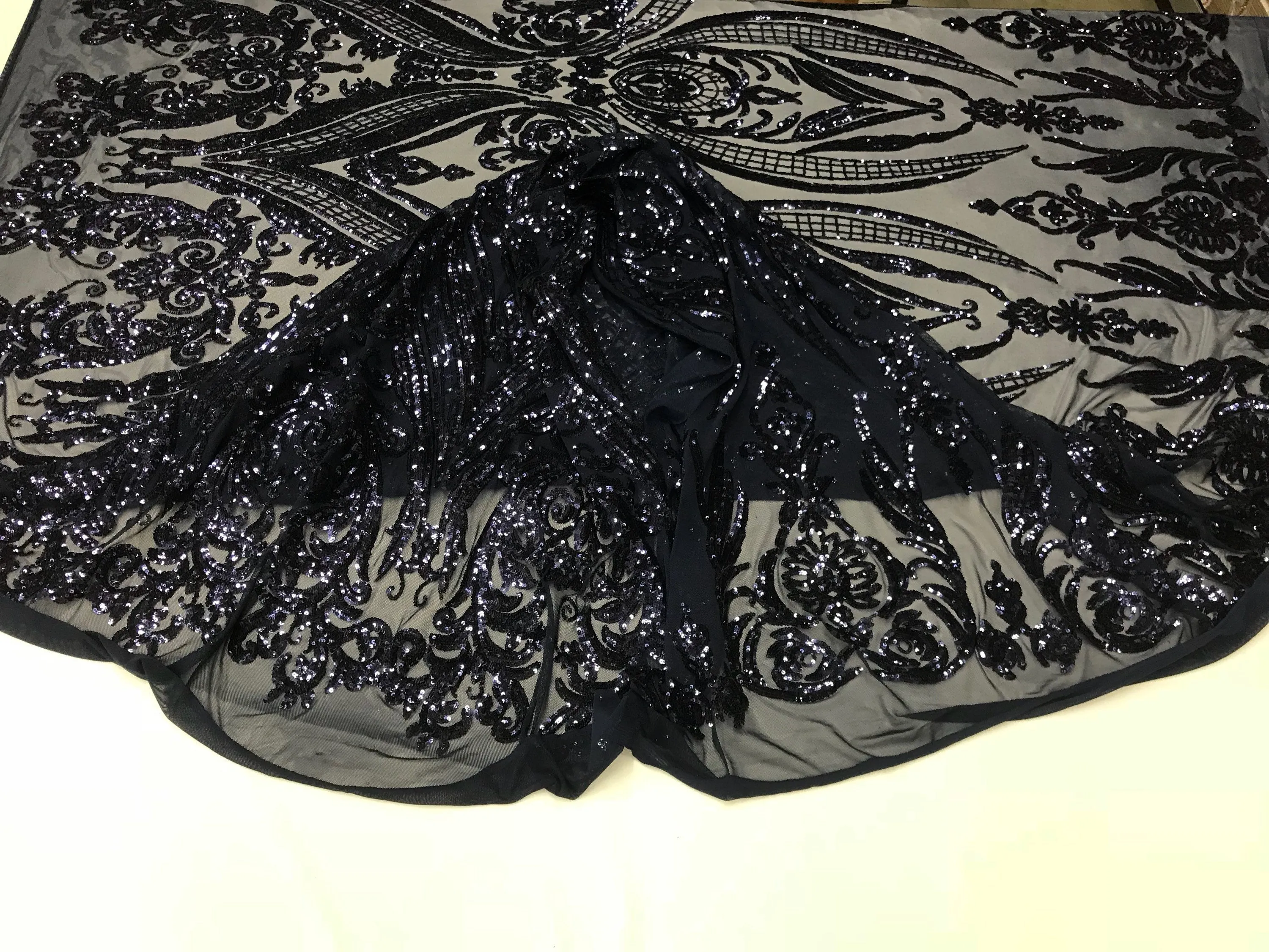 Navy blue princess design embroidery with shiny sequins on a 4 way stretch mesh-sold by the yard.